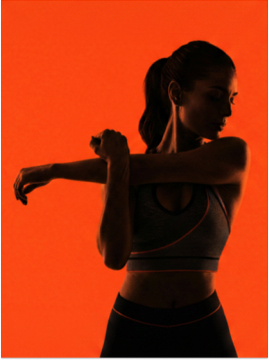 Athlete stretching with orange lighting
